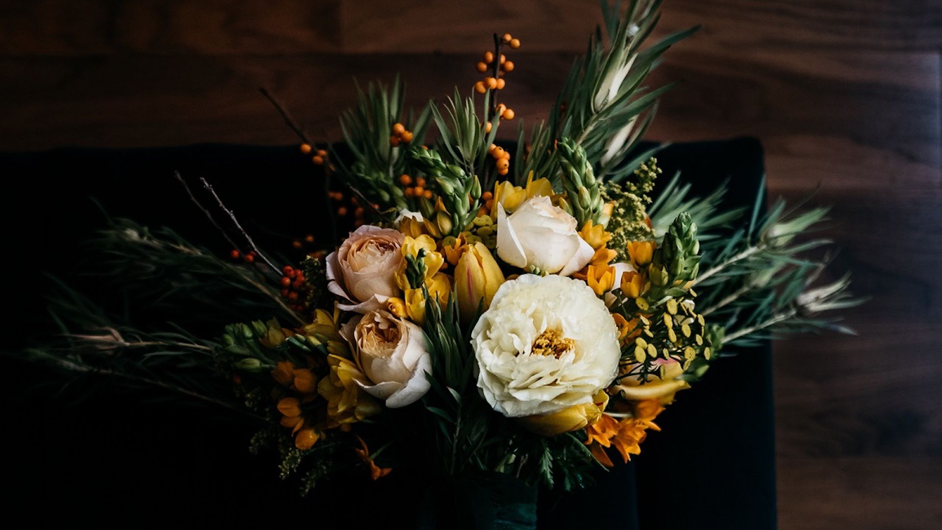 A Bouquet Of Flowers In A Vase On A Table